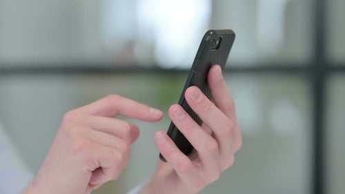 Close Up of Young Man Using Smartphone