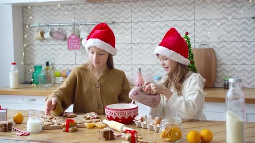 Young Women Baking Christmas Cookies Together at Home