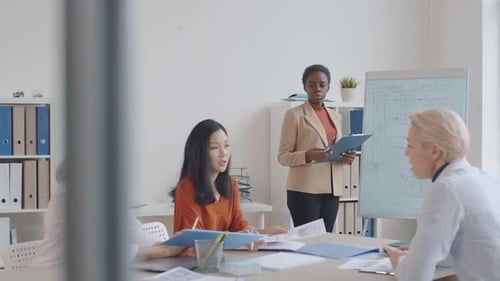 Diverse Women Collaborate in Bright Office Meeting