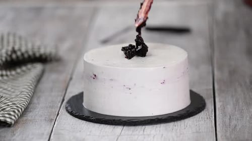 Confectioner Decorates Cake with Blackcurrant Jam.