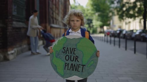 Child Holding Save Our Planet Sign