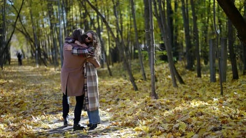 Happy Loving Couple is Embracing in Park in Autumn Man is Holding Girlfriend in Hands and Whirling