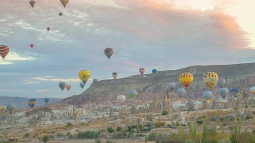 Colorful hot air balloons flying over rock landscape at Goreme, Cappadocia, Turkey