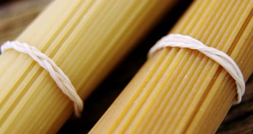 Close Up of Bundled Raw Spaghetti on Wood