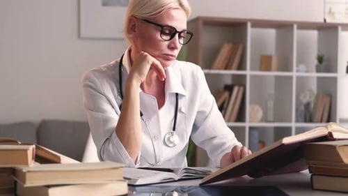 Woman Doctor Reads Medical Books in Home Office
