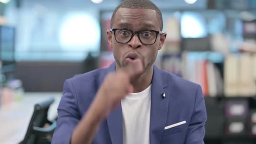 Man Talking to Camera in Business Setting