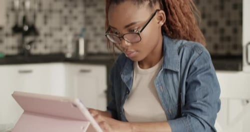Woman Studying with Tablet at Home