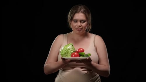 Woman Holds Plate of Healthy Vegetables and Smiles