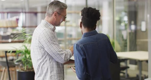 Business Professionals Discussing Data and Shaking Hands