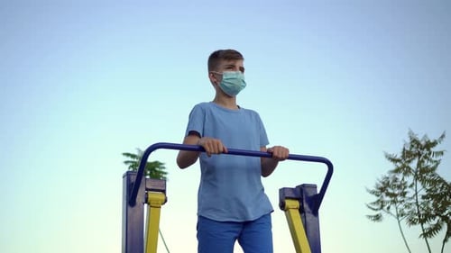 Teen Exercising Outside on Outdoor Exercise Machine