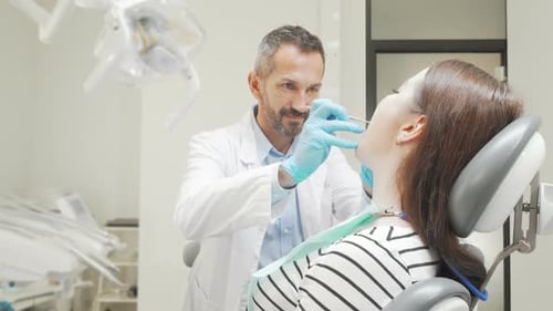 Dentist Examining Patient in Modern Clinic