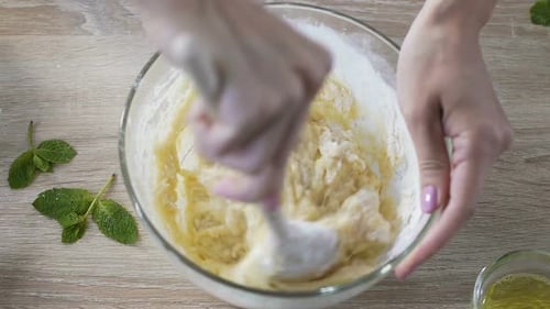 Mixing Dough in Glass Bowl with Spoon