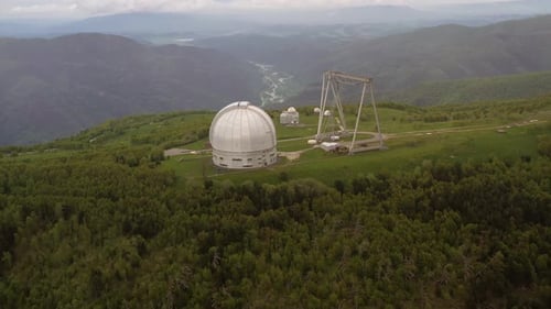 Aerial View of White Observatory in Mountainous Landscape