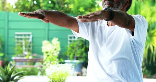 Senior man exercising at home