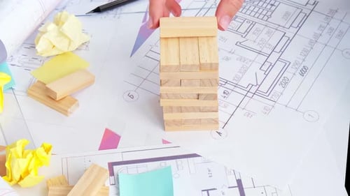Architect Playing Jenga on Floorplans