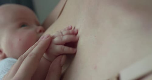 Mother Breastfeeding Infant in Gentle Close-Up