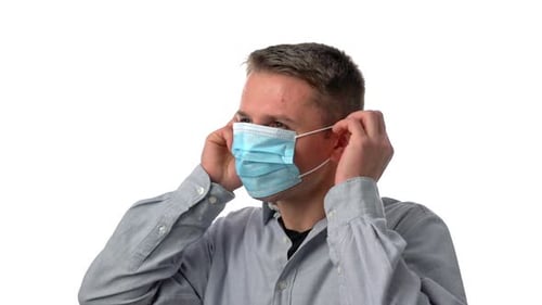 Young Adult Putting on a Surgical Mask