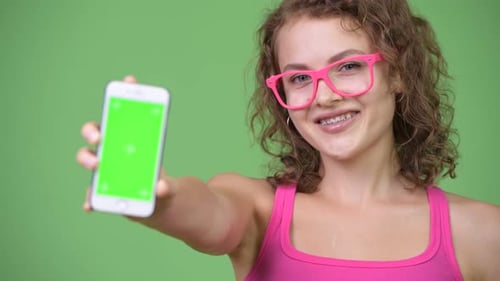 Young Adult Showing Smartphone with Green Screen