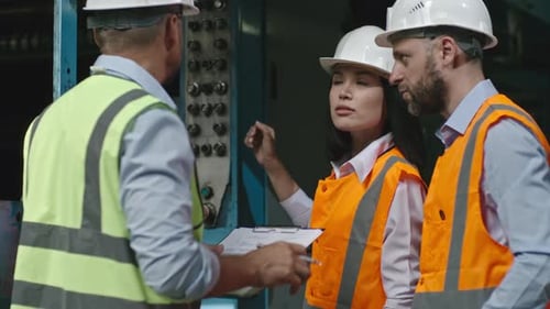 Female Engineer Describing Industrial Machinery