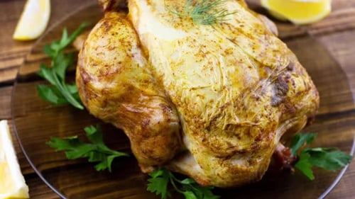 Roasted Chicken Garnished with Dill, Parsley and Lemons