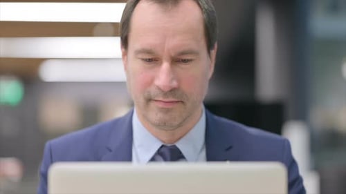 Man in Suit Gives Thumbs Up
