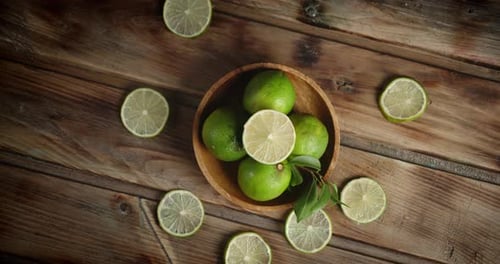 Fresh Green Limes on Rustic Wooden Table
