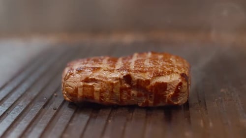 Piece of Fresh Juicy Beef with Traces of Grilling Lies on the Grill and Hovers Over the Hot Surface