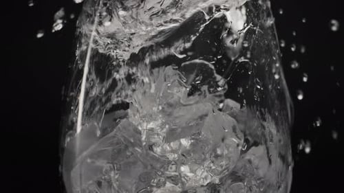 Splashed Water Pouring Ice Glass Closeup Slow Motion