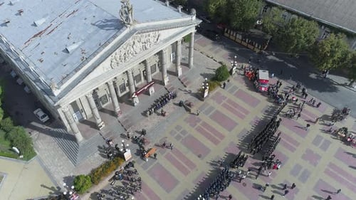 Aerial view of a military parade in front of the Theatre