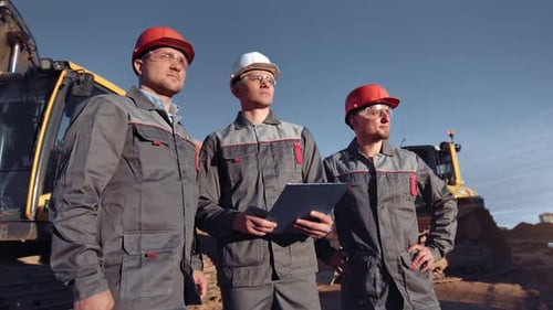 Team of Professional Male Builder Worker in Construction Site at Sunset Medium Shot