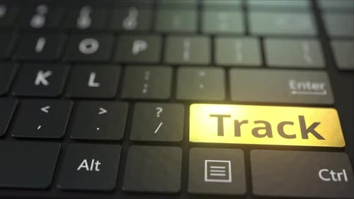Black Computer Keyboard and Gold Track Key