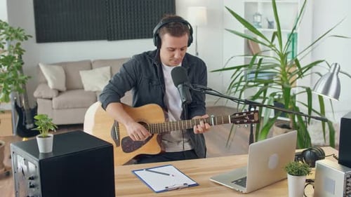 An Influential Musician With a Guitar Writes Music at Home Music Studio Spbd