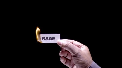 Card with Word 'Rage' Burns Away in Fire