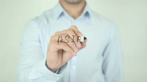 Man Writes the Word Asian with Marker