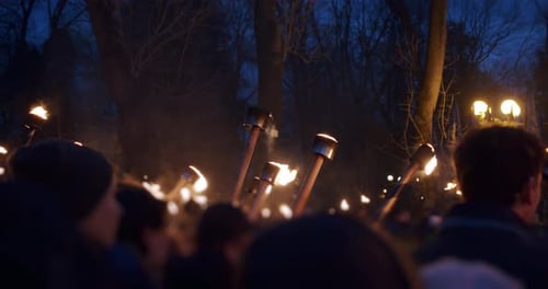 Slow Motion. Many Protesters Holding Burning Flare on Night Street in Smoke.