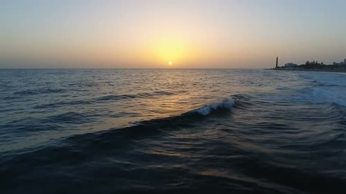 Aerial Flight Above Ocean To Sunset