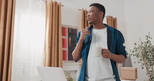 Young Adult Using Computer in New Apartment