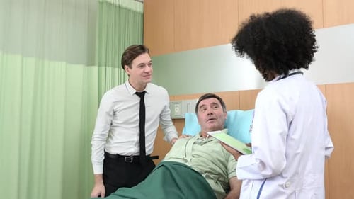 Patient Consulted by Doctor with Visiting Young Man