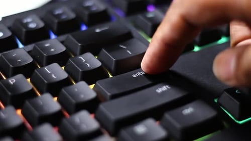 Finger Pressing Enter Key on Computer Keyboard