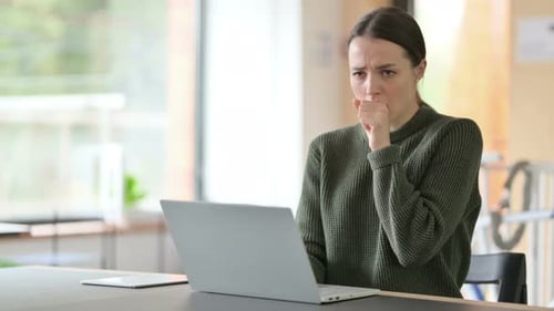 Woman Coughing While Working at Computer
