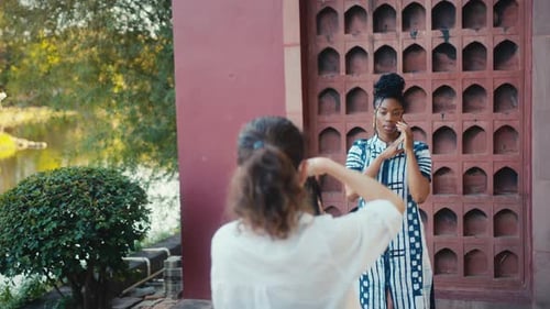 Stylish Woman Modeling near Decorated Wall
