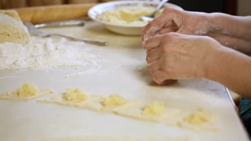Hands Crafting Potato Dumplings at Home