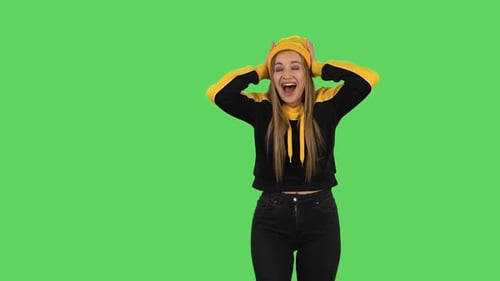 Modern Girl in Yellow Hat with Shocked Surprised Wow Face Expression Is Rejoicing. Green Screen