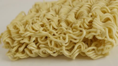 Panning over tasty Chinese noodles close-up 4K 2160p 30fps UltraHD footage - Instant staple food