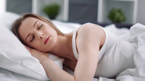 Woman Sleeping Peacefully in Bed at Home