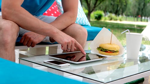 Young Man Uses Tablet Outdoors