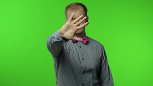 Man Raising Hand Warning of Danger, Showing Stop Gesture, Protecting From Danger. Telling To Stop