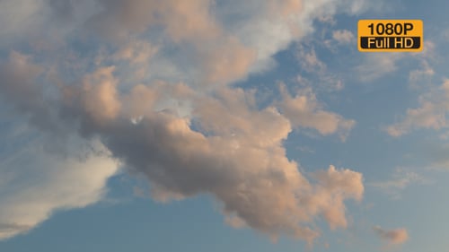 Pink Clouds Float Gently Across Blue Sky