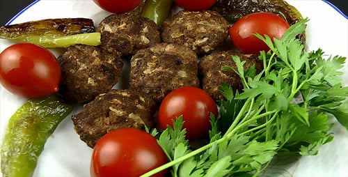 Close Up of Meatballs with Tomatoes and Peppers