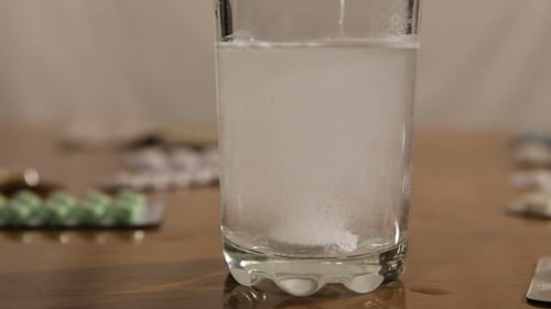 Effervescent Tablet Dissolving in Glass of Water